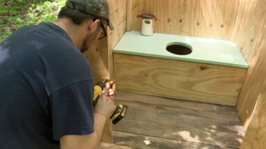 Building an outhouse at a remote off-grid wilderness camp